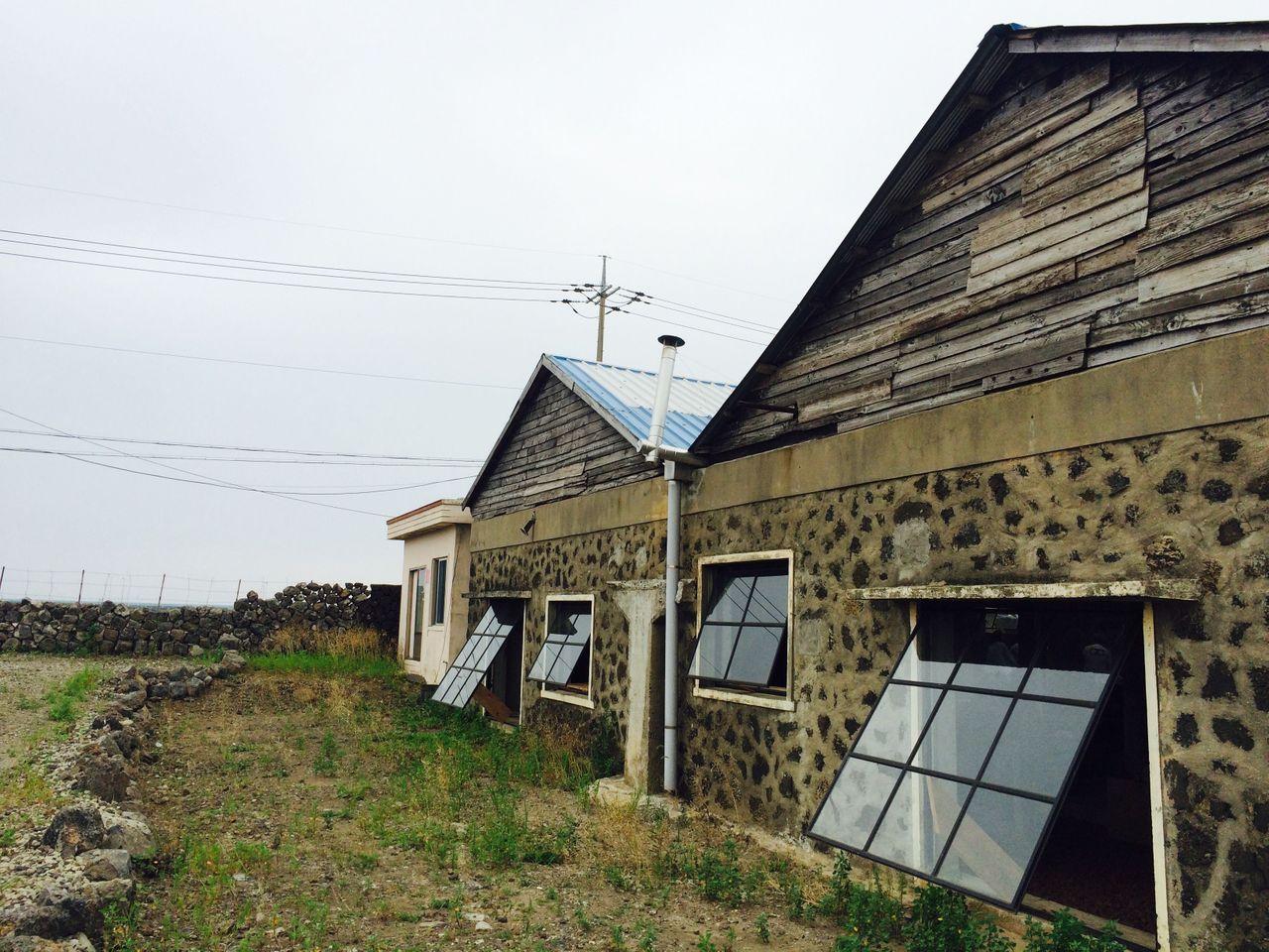 Anthracite Cafe in Jeju Island with a rustic exterior made from preserved traditional Jeju stone architecture.